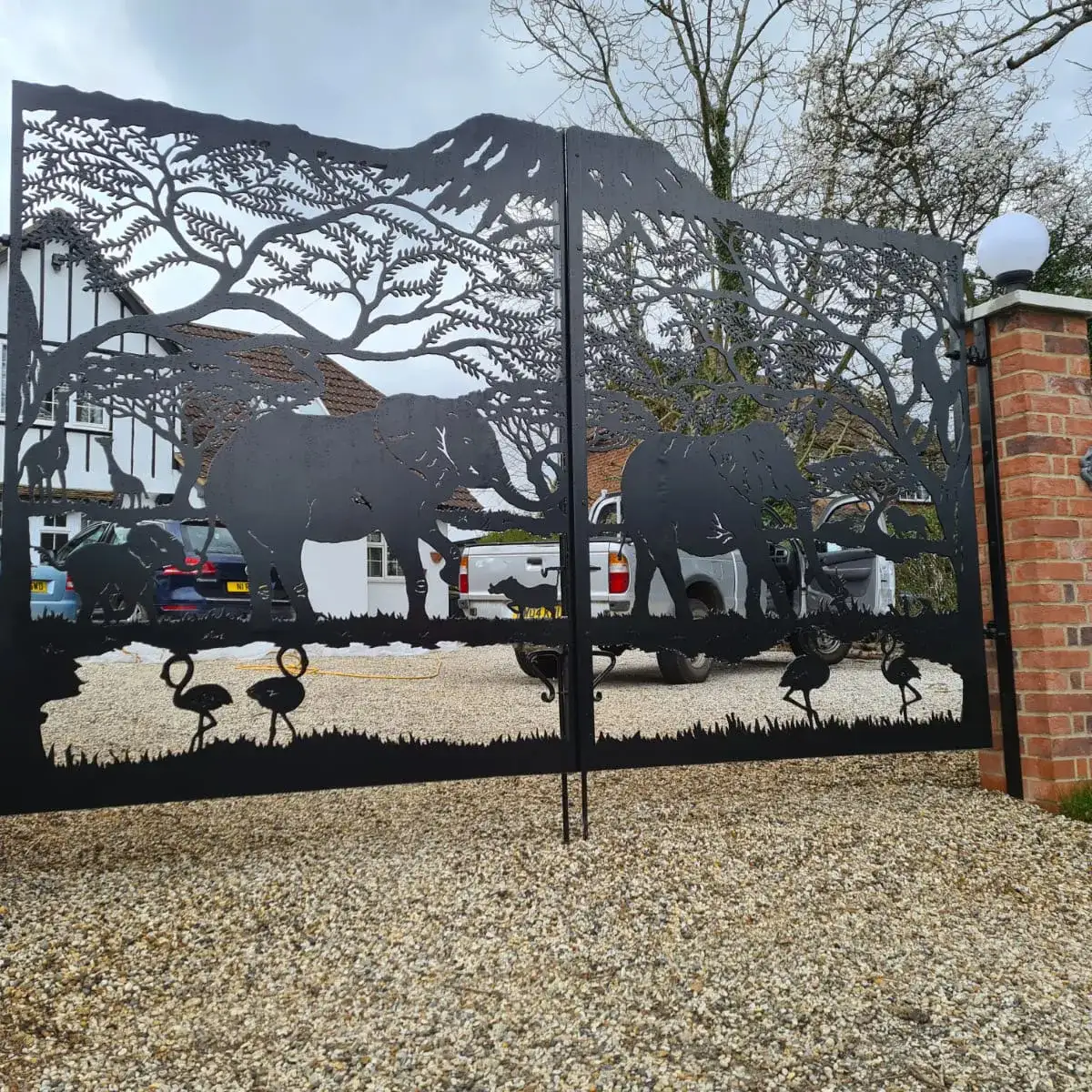 a large metal gate with a picture of elephants on it