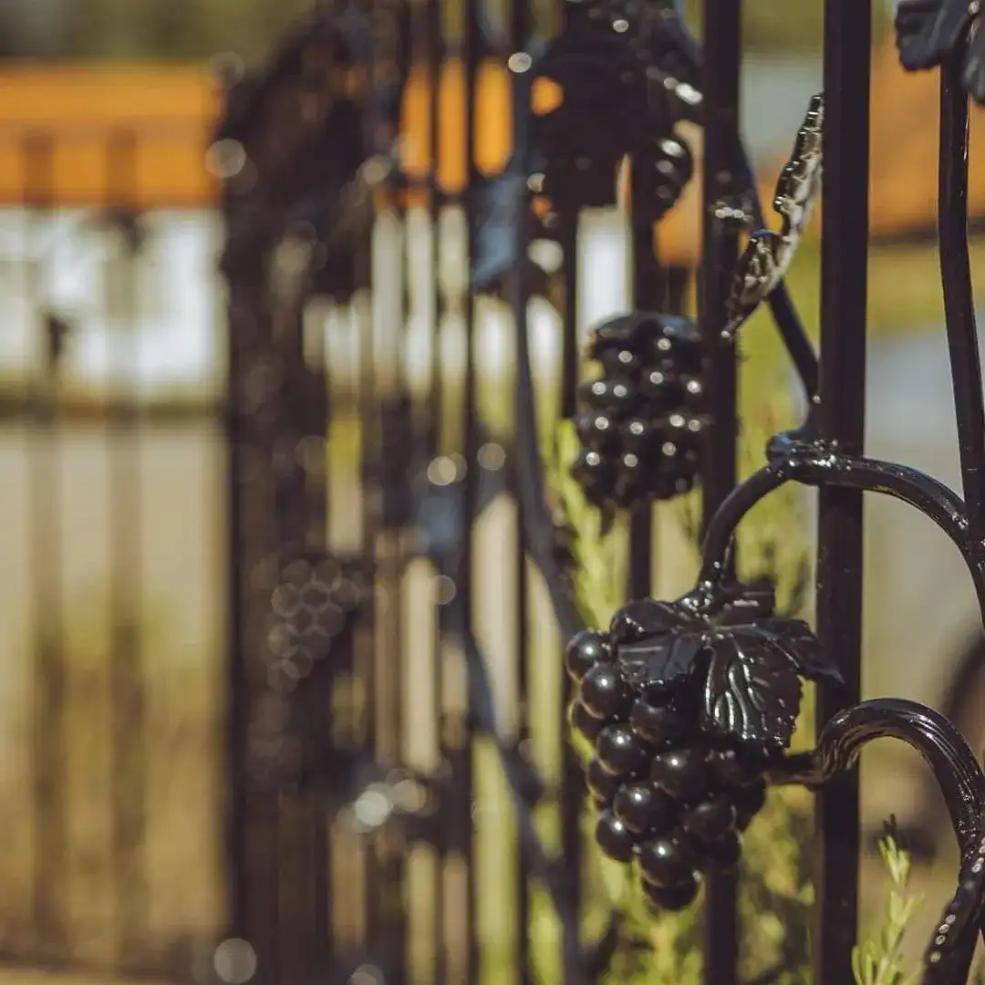 a close up of a wrought iron fence