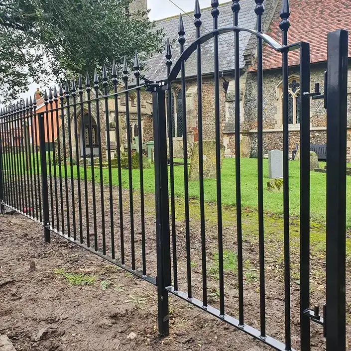 a black iron fence in front of a church